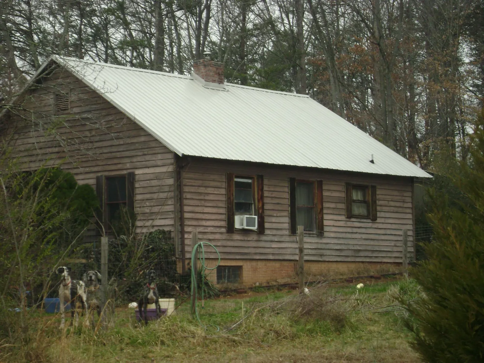 White metal roof on an old wood sided farmhouse, from a Metal Roof Installation job in Conehatta